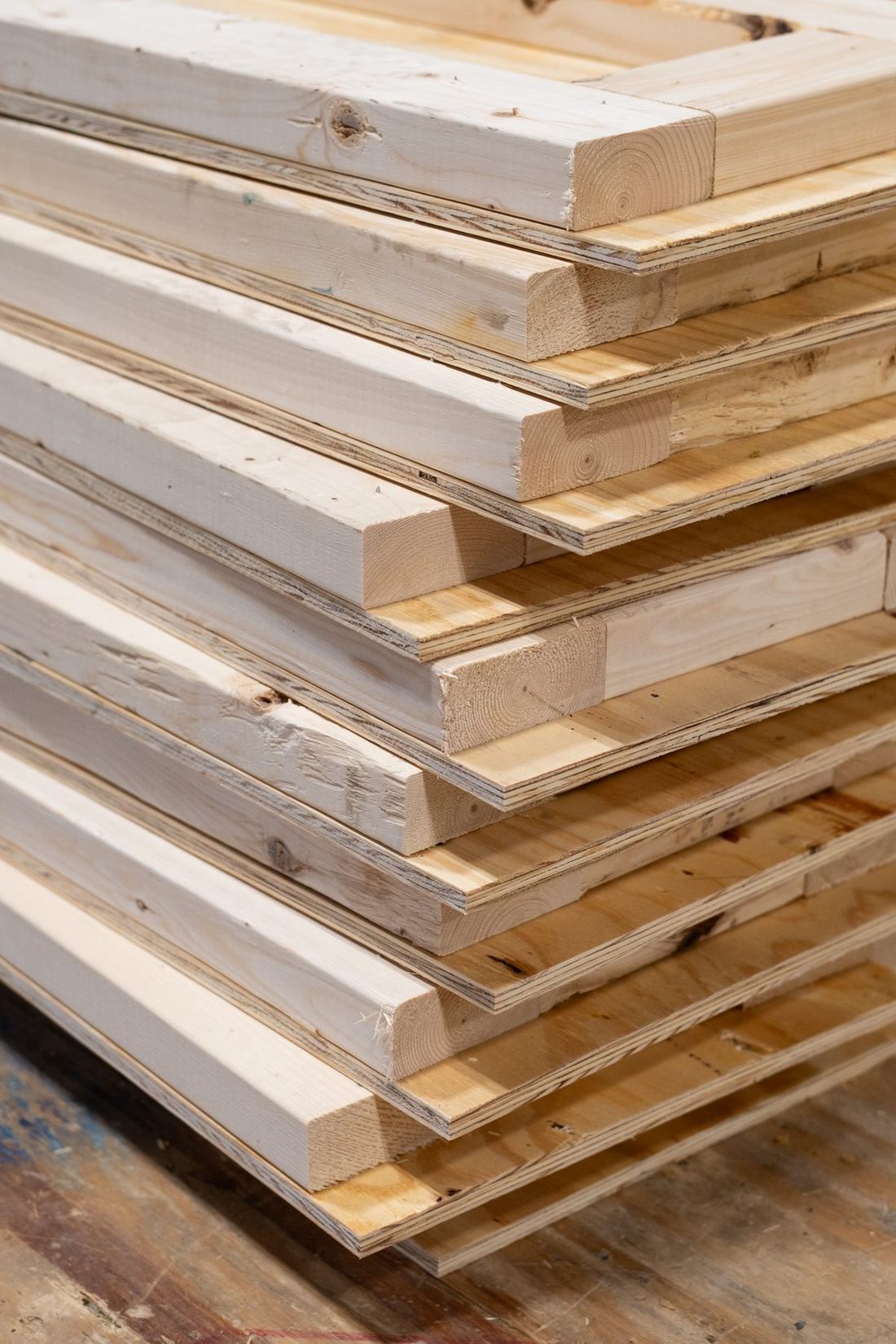 A stack of finished timber panel frames waiting to be filled
